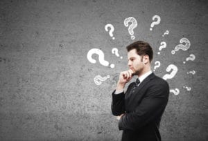 thinking man with question marks around his head - looking for answers about an agency group