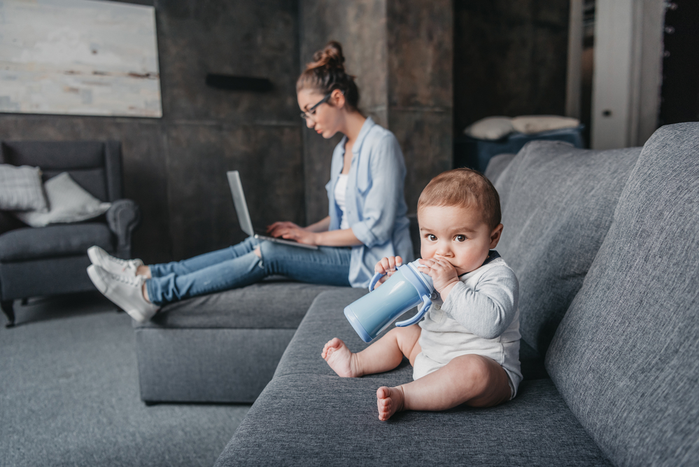 work at home - Mom and baby on the couch, Mom with laptop