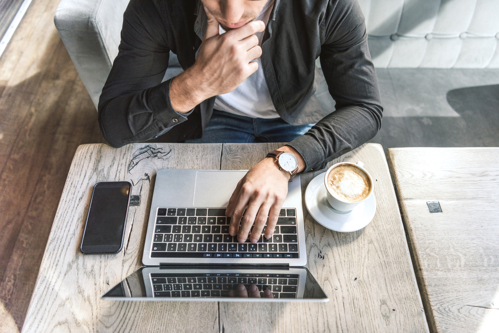 man on laptop watching Covid-19 Insurance Webinar series