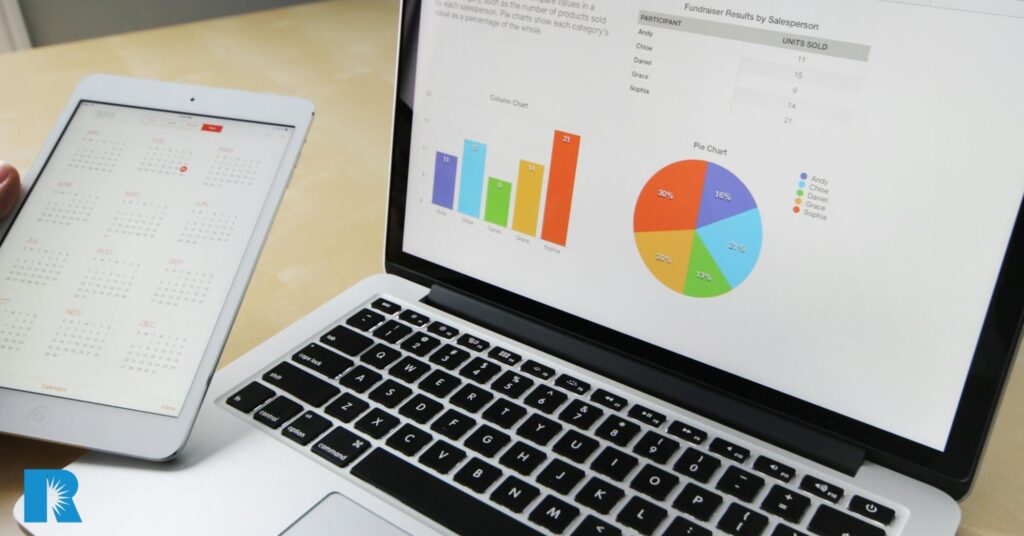 A photo showing a tablet and a MacBook, both using agency technology software.