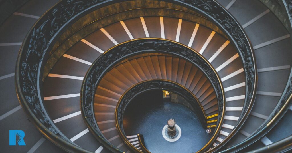 A photo showing three flights of a spiral staircase.