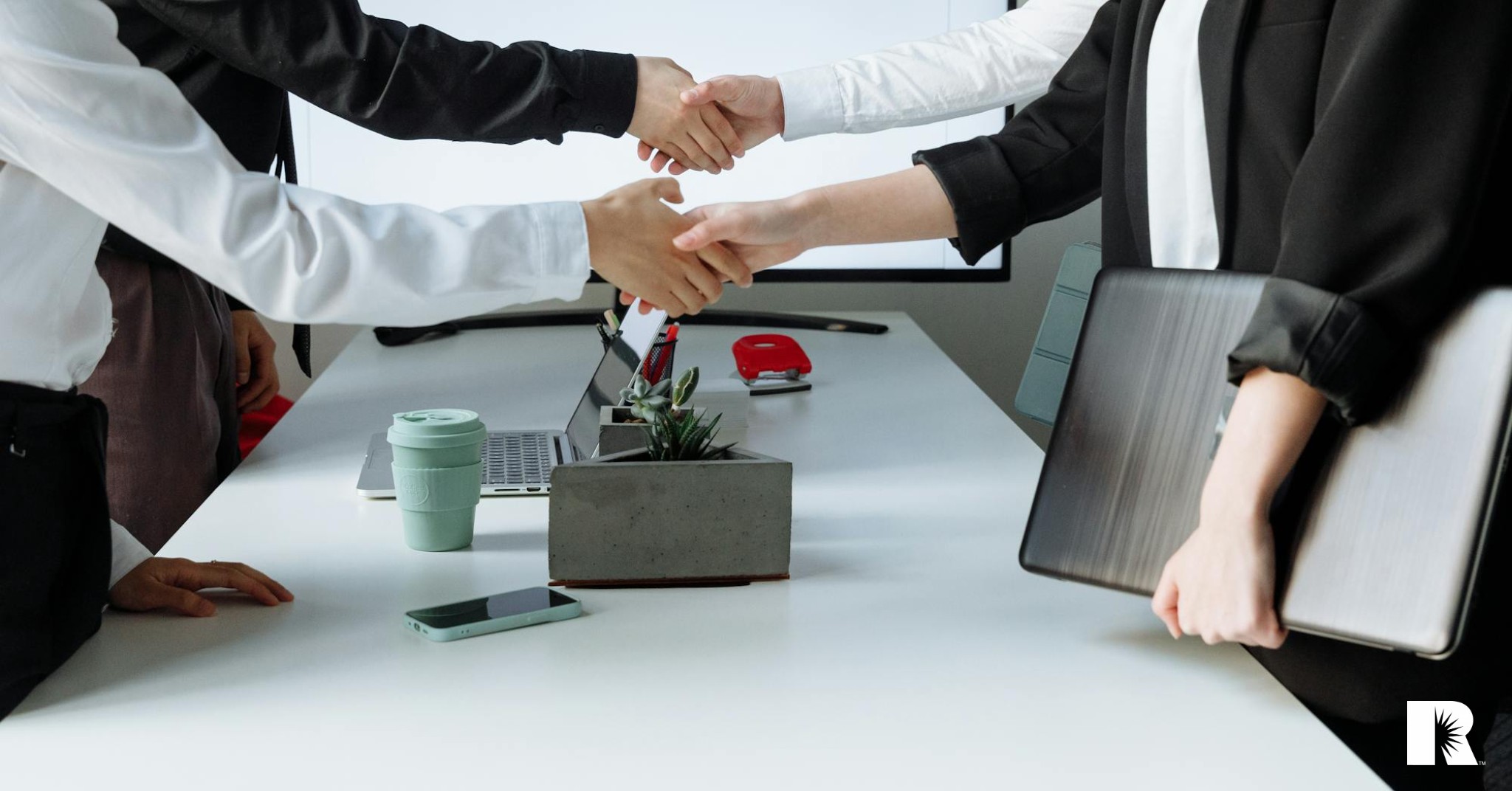 Several people shaking hands over a beneficial business deal.