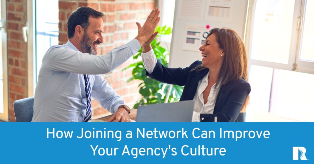 Two insurance agents share a high-five over their decision to join an agency network.