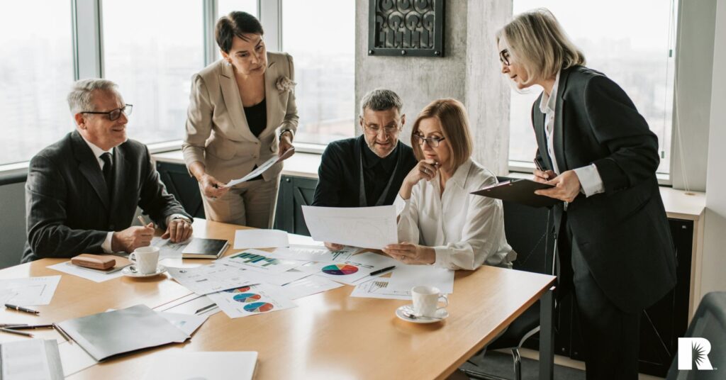 The staff of a large insurance agency gathers for a meeting.