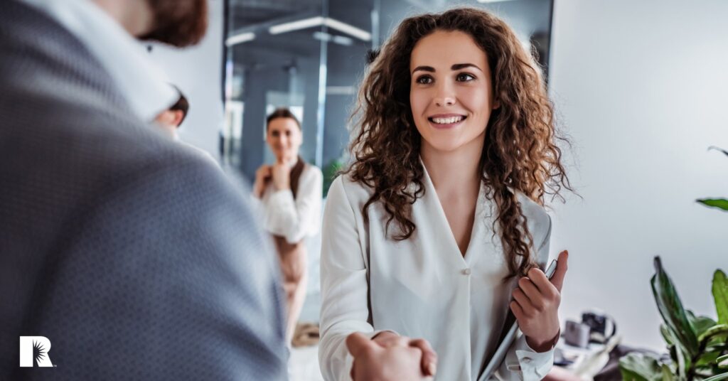 A young agent greets a client.