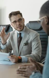 An insurance agent speaks with one of his carrier representatives.