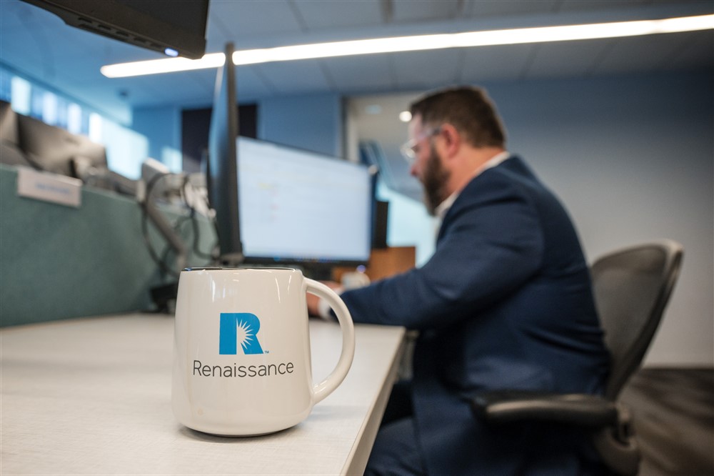 An insurance placement services team member working at his desk