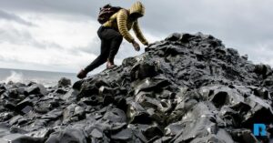 Photo illustration of a man navigating treacherous terrain.