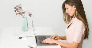 A woman works at her computer.