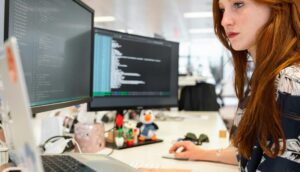 An insurance agent works at her computer in her office.